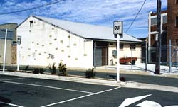 Colour picture: the AMRA NSW Rockdale clubrooms in 2000; view from the carpark on the other side of Chapel Lane. It is the widening of this lane that requires the demolition of the building.