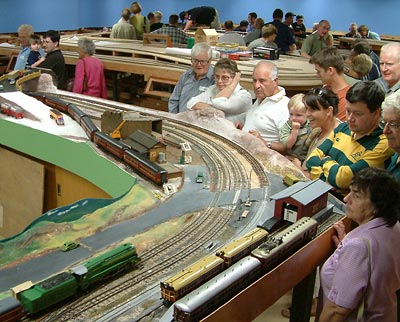 An Open Day crowd fills the corridors between the O gauge layout (foreground) and the HO (background)